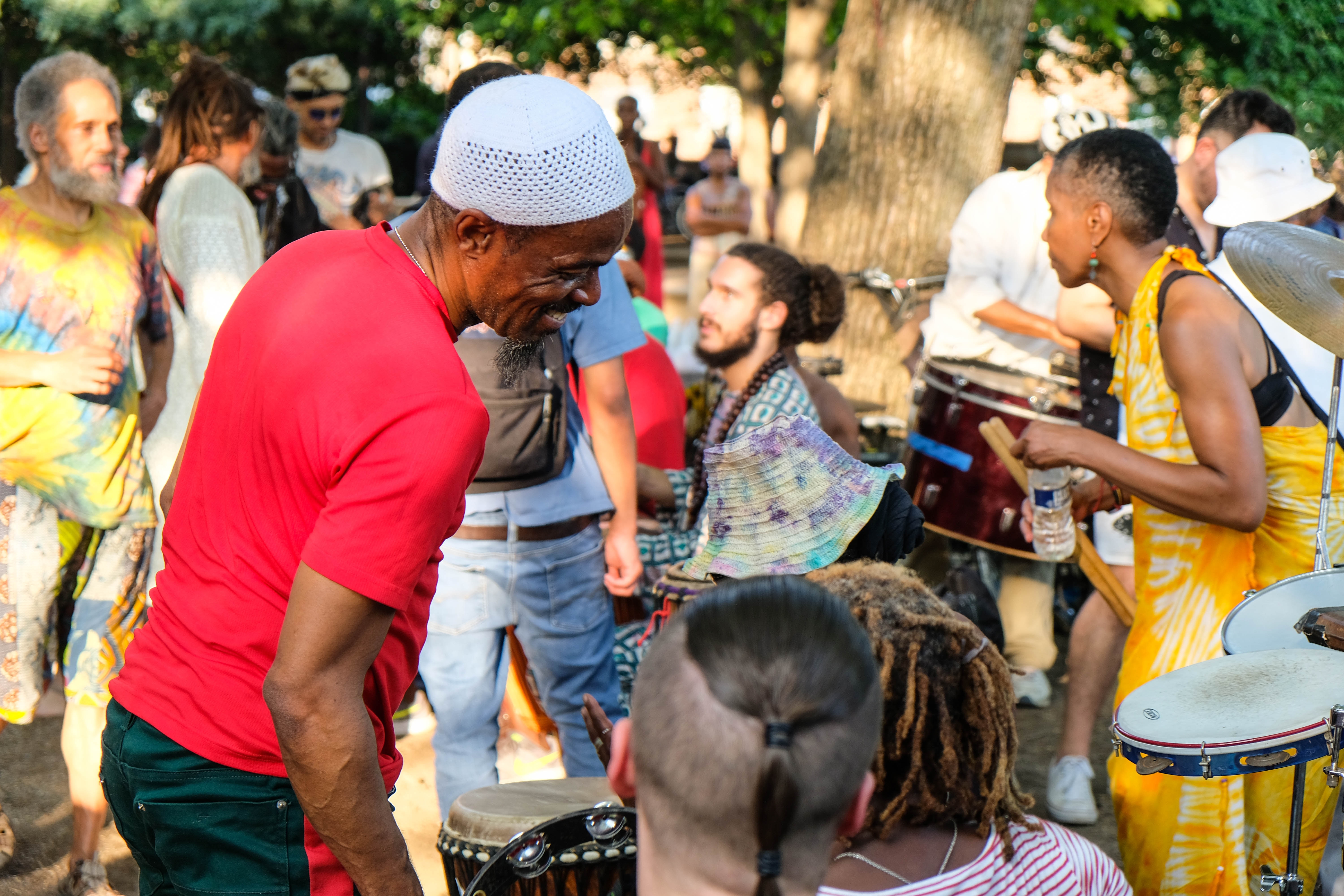 Community gathering with people playing drums together